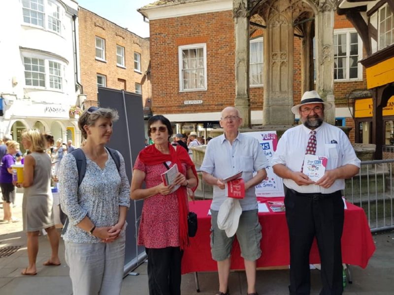 Smiling members of Winchester and Romsey Labour man the August Street Stall